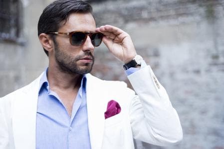 male model holding sunglasses