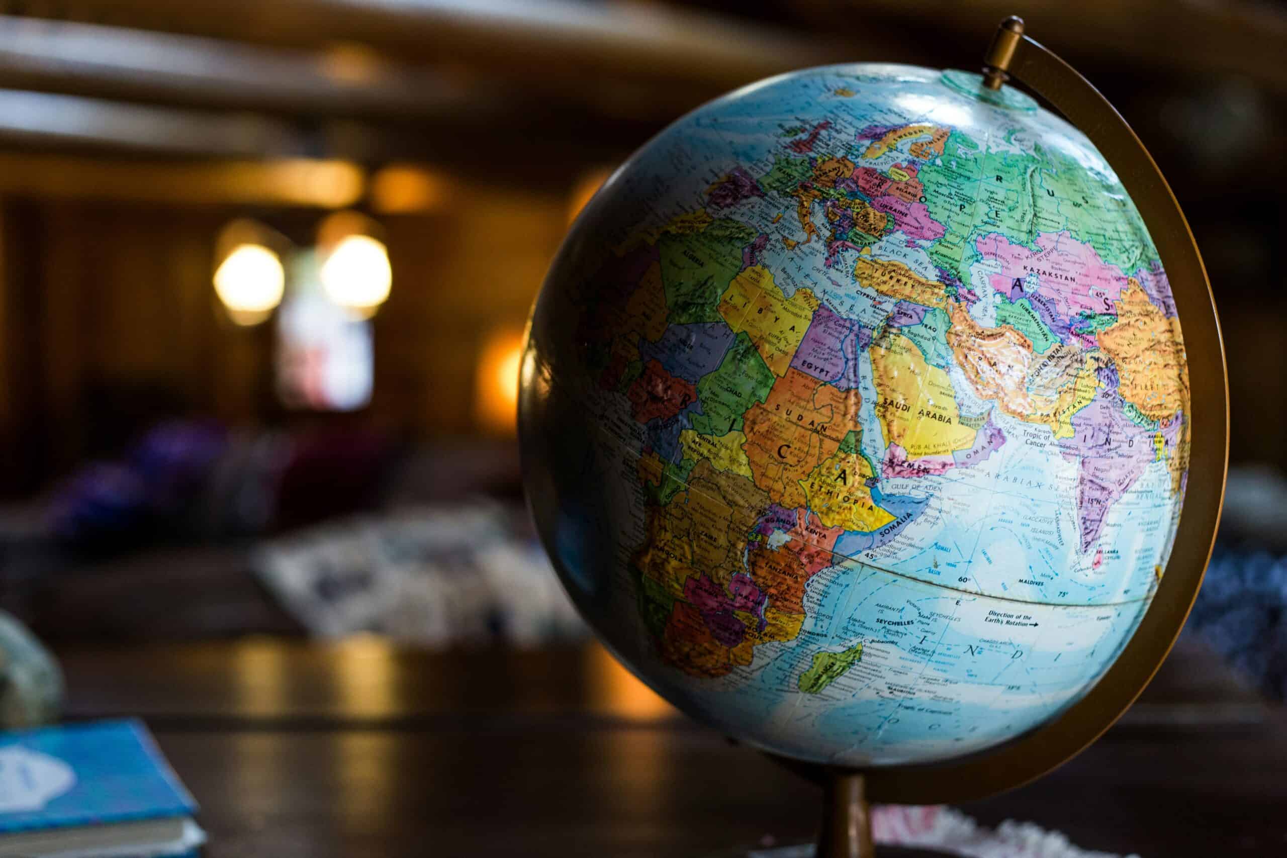 Colorful world globe showcasing Africa, Asia, and the Middle East in a cozy indoor setting.