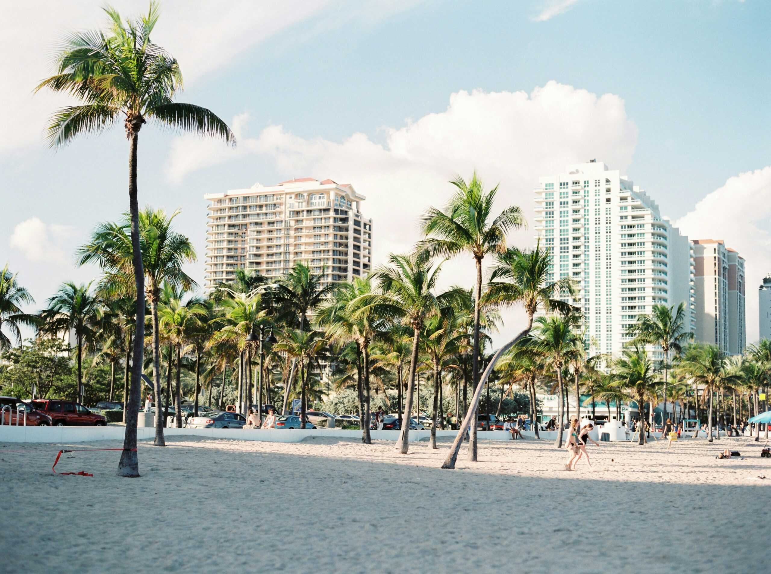 Miami skyline at dusk with palm trees and waterfront, illustrating the city’s role in geo-smart fashion recruiting for resort and swimwear talent.