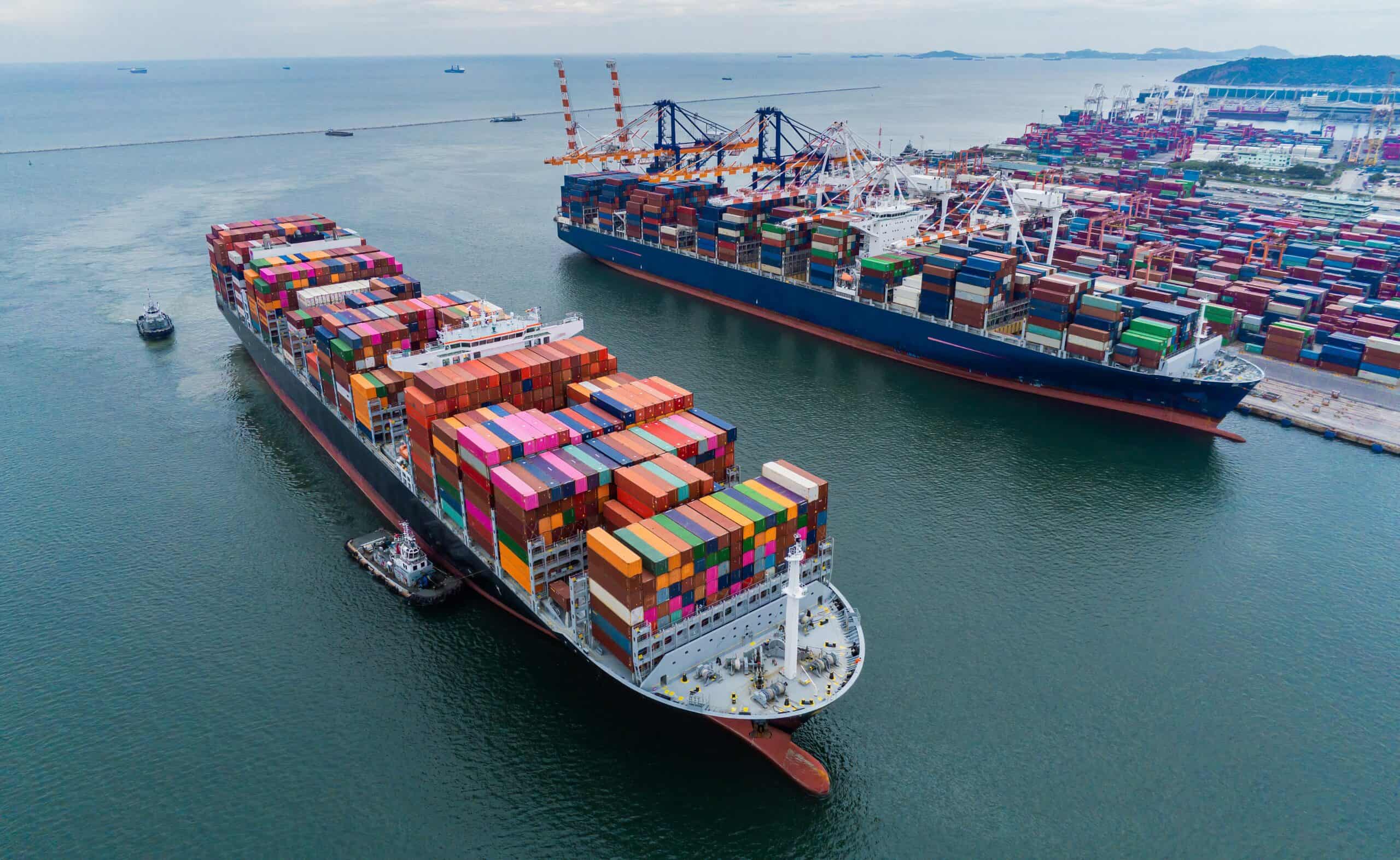 "Aerial view of cargo container ships at port, representing the global supply chain disruptions from tariffs affecting the fashion industry