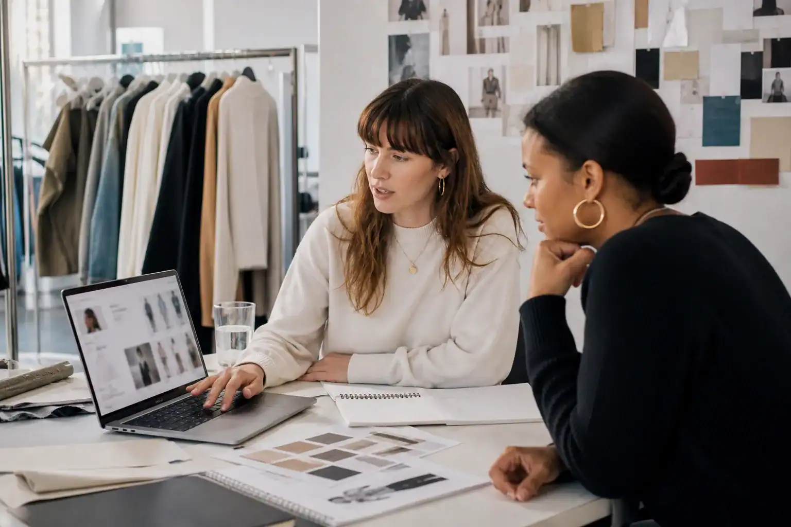Fashion recruiter reviewing a visual candidate portfolio with a colleague.