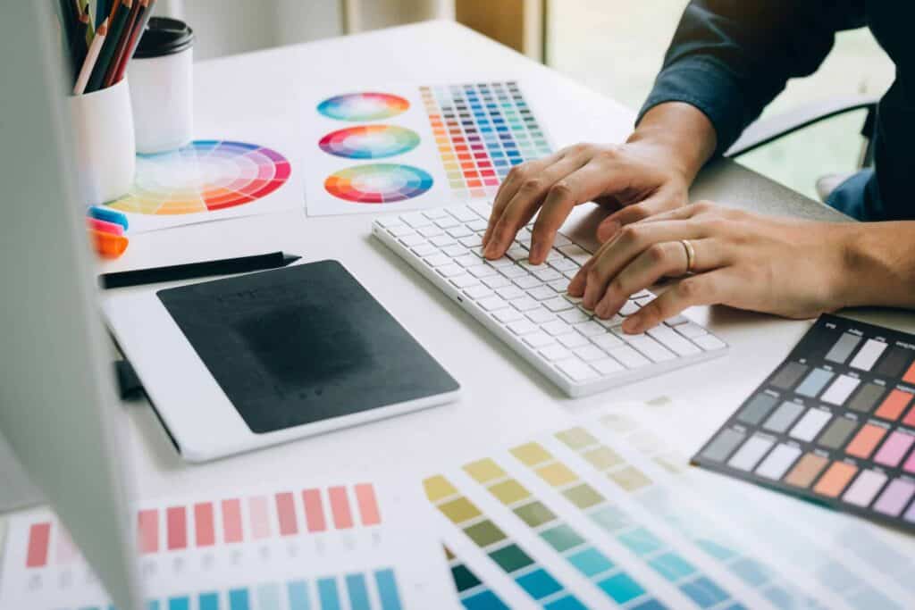 Vibrant color palette and design tools at a creative fashion studio workspace.