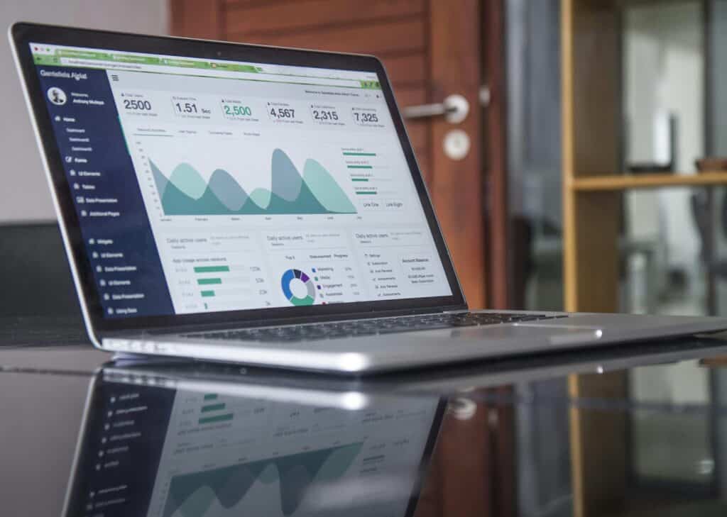 Open laptop displaying analytics dashboards and sales performance metrics, symbolizing data-driven omnichannel merchandising strategies used by fashion e-commerce recruiters.