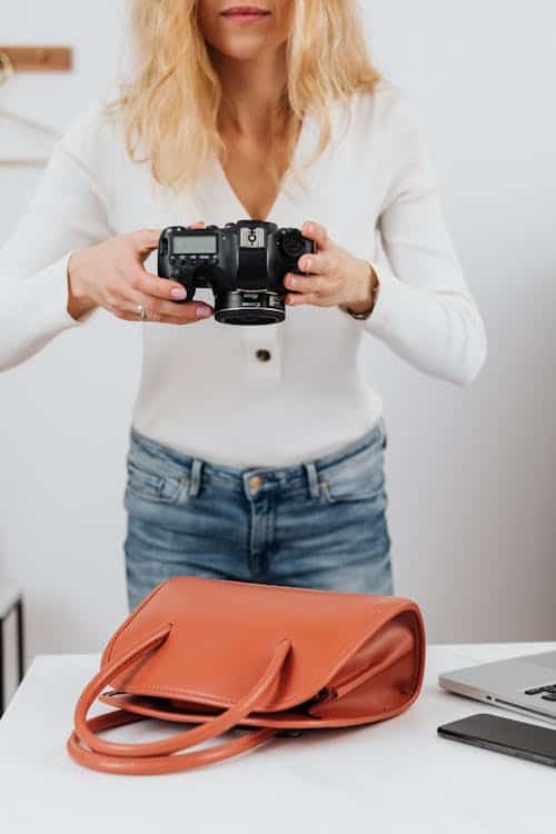Fashion Recruiter vs. Generalist Staffing Agency: What’s the Difference? 2 Ecommerce product photographer capturing a handbag for an accessories brand showing the digital commerce talent a fashion staffing agency recruits