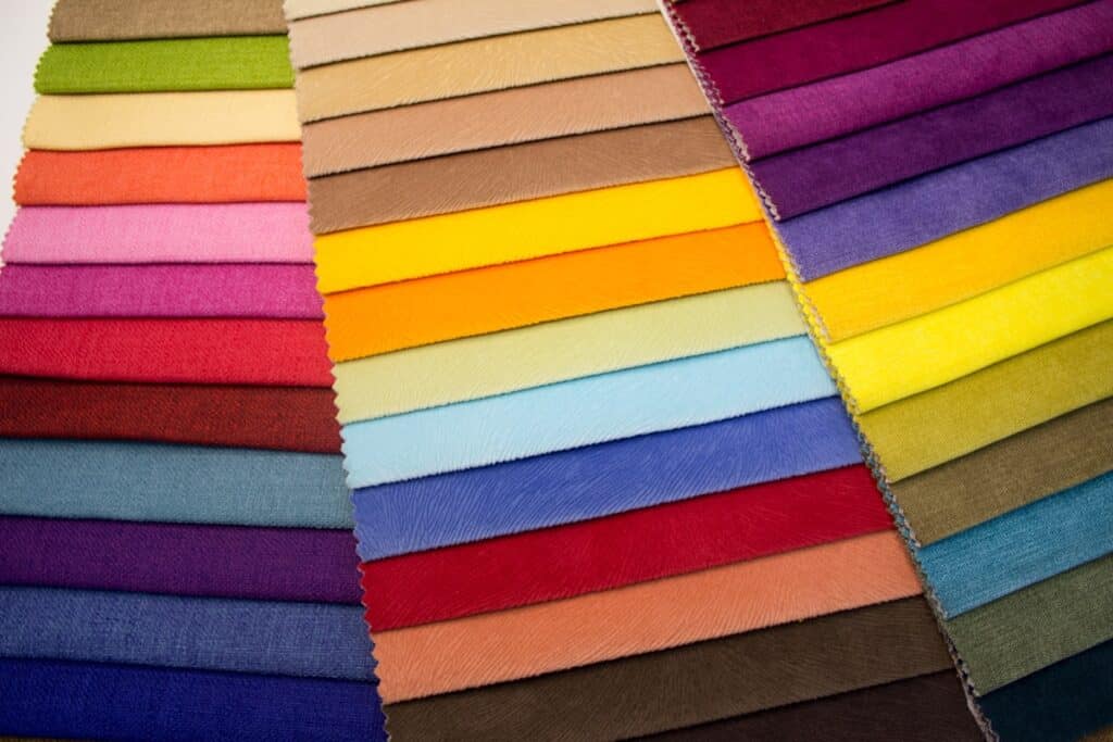 fashion buyer hiring fabric swatches laid out for assortment review